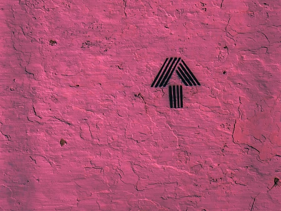 black arrow on pink wall