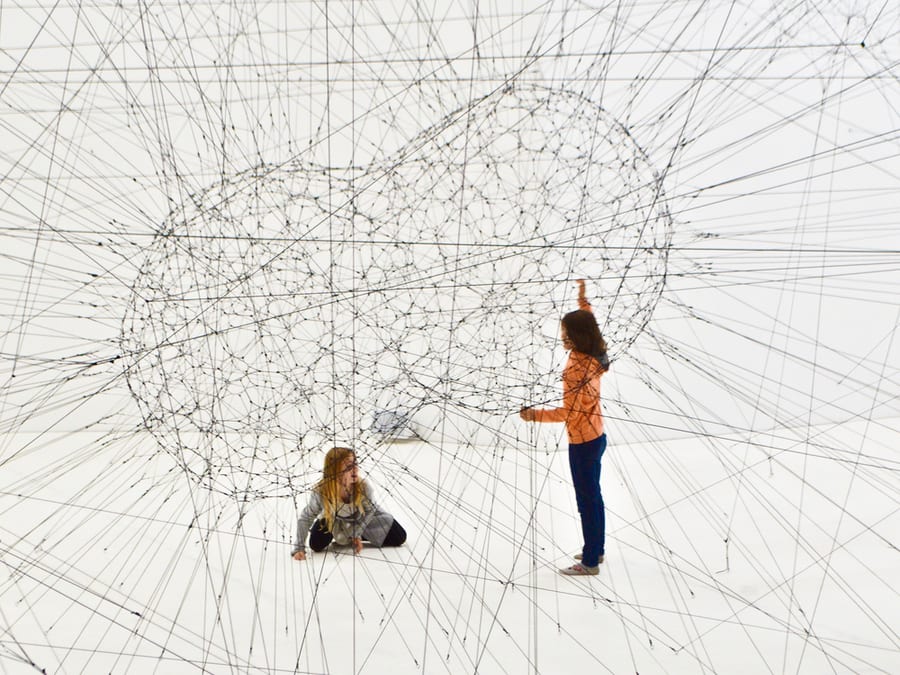 people interacting with geometric design
