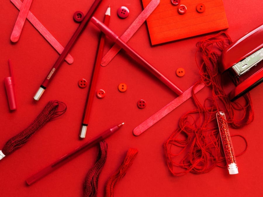 red office supplies on red background